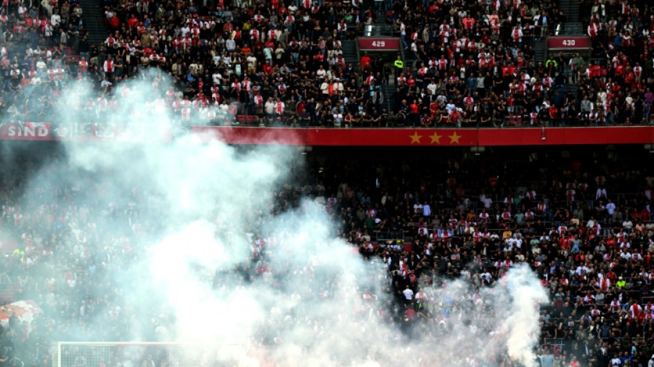 Ajax-Feyenoord abandoned after flares lobbed on pitch