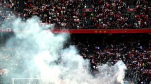 Ajax-Feyenoord abandoned after flares lobbed on pitch