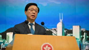 Hong Kong leader says wanted activists should give up or live 'in fear'
