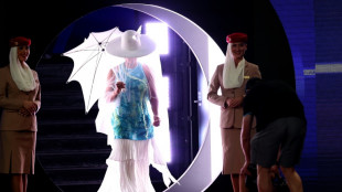 Osaka emerges for Melbourne opener under hat, veil and parasol