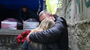 Ukrainian village buries its dead after Russian attack