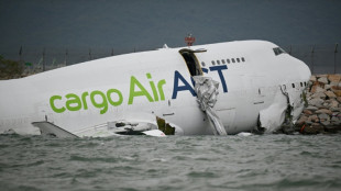 Cargo plane skids off Hong Kong runway, kills 2